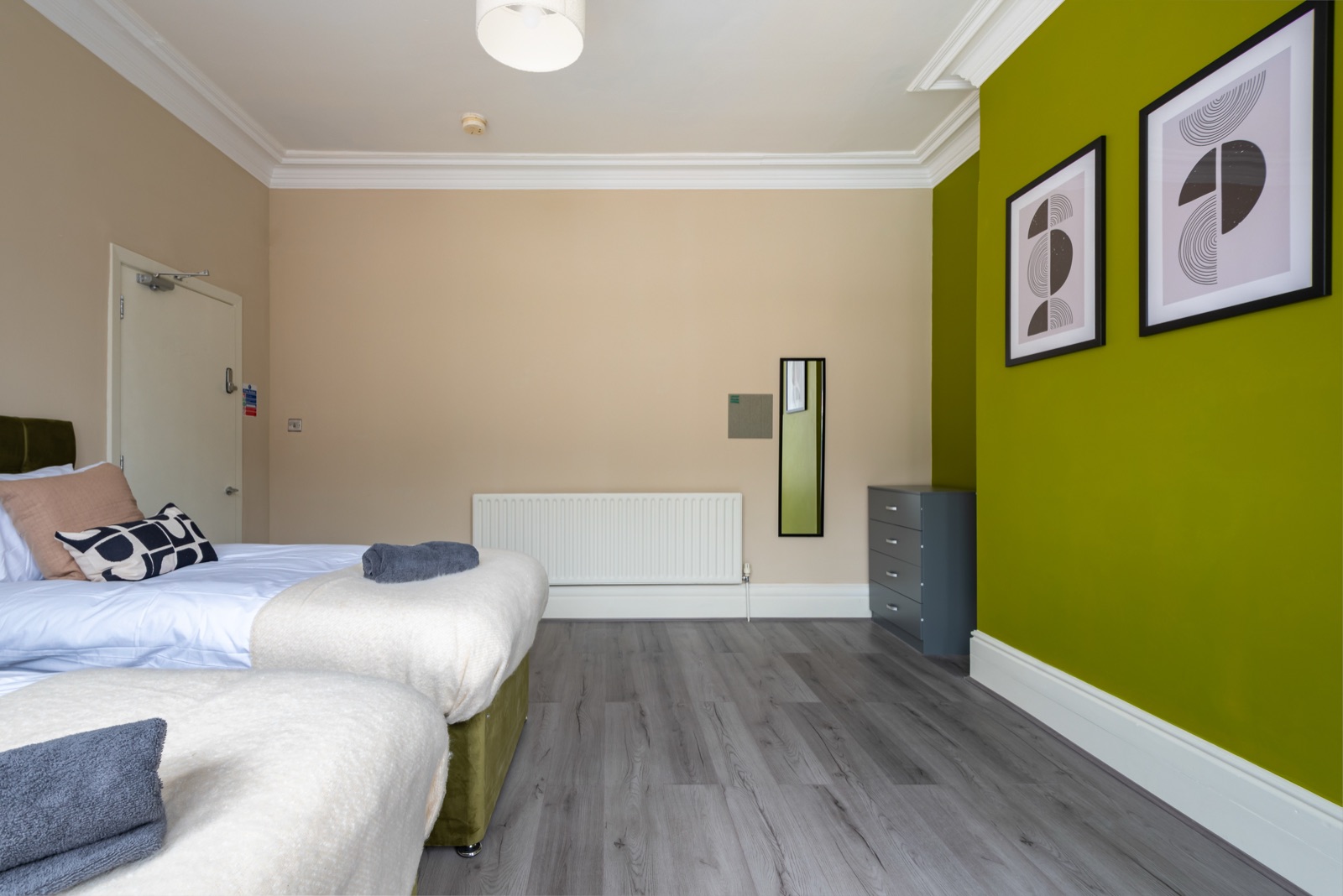 Twin bedroom at Ash Grove House — green accent wall