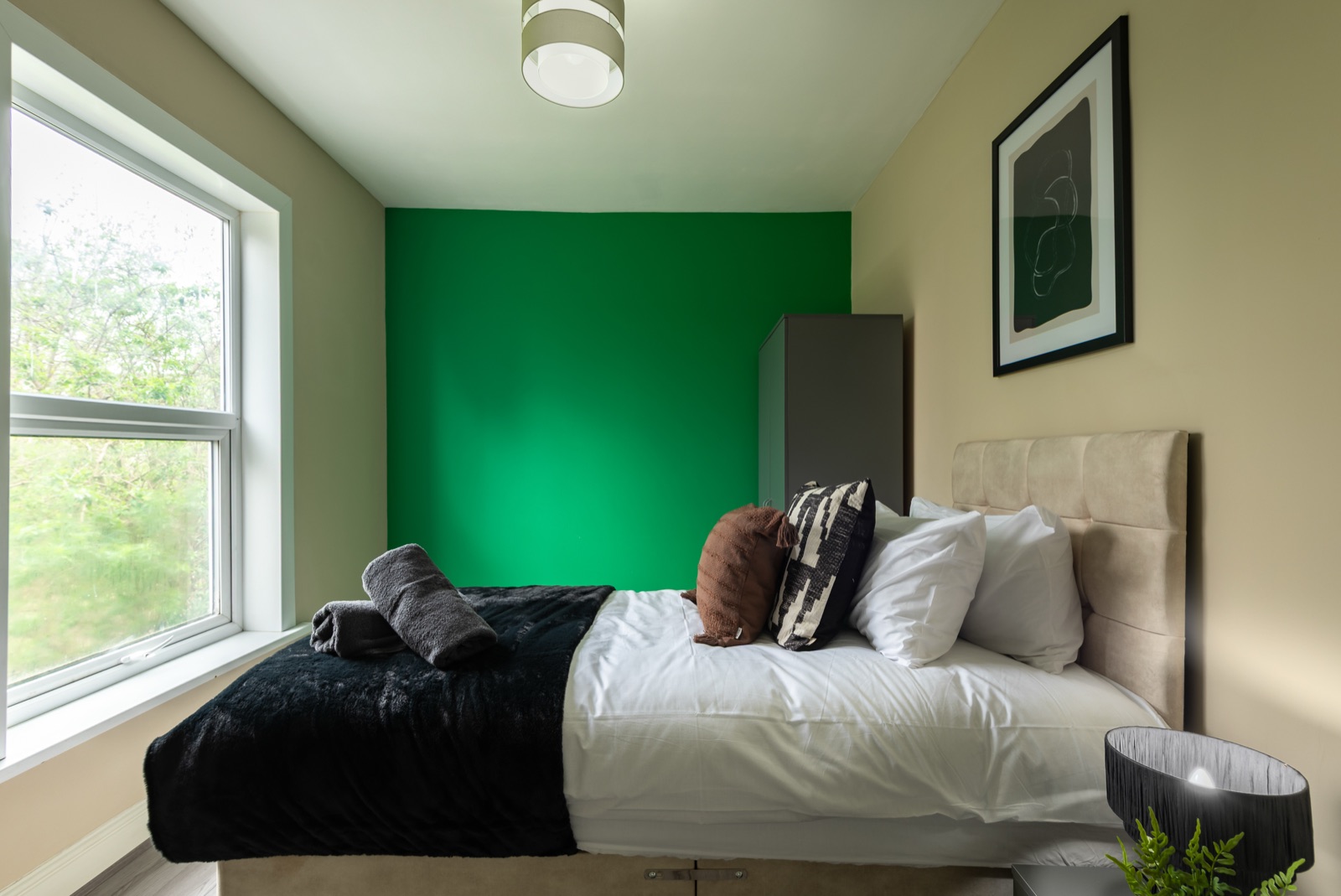 Bedroom at Ash Grove House — emerald accent wall