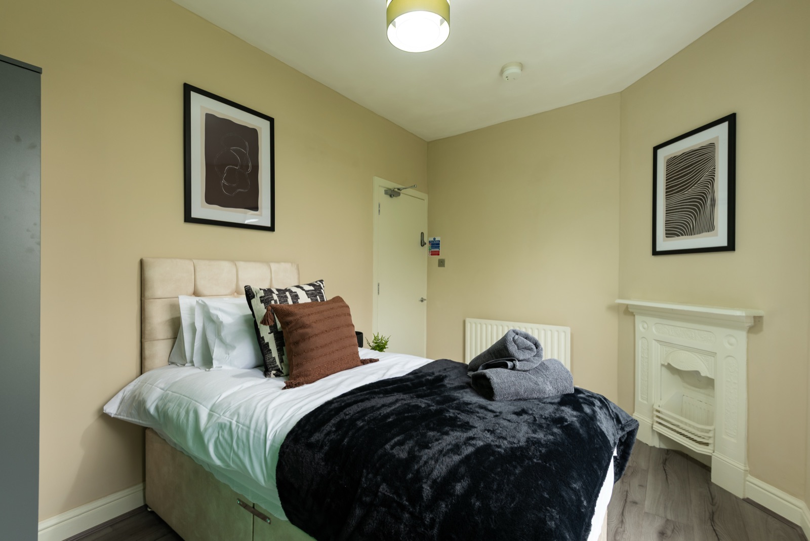 Bedroom at Ash Grove House — cream walls with original fireplace