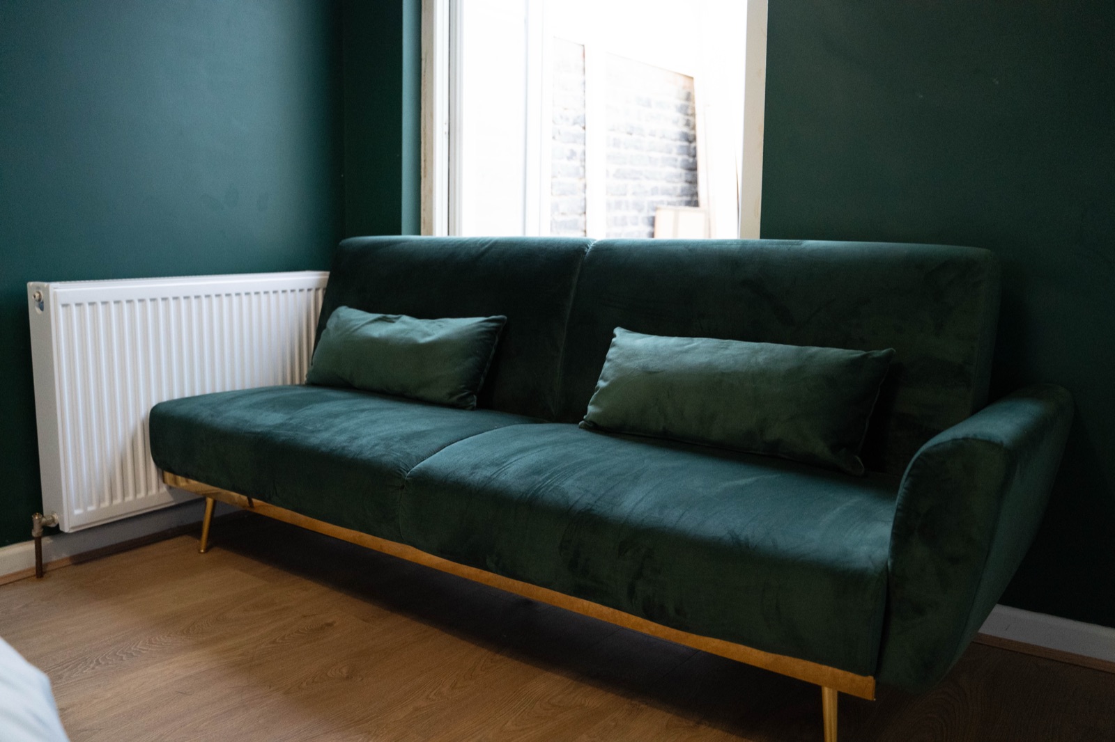Living room at Cecil House — green velvet sofa