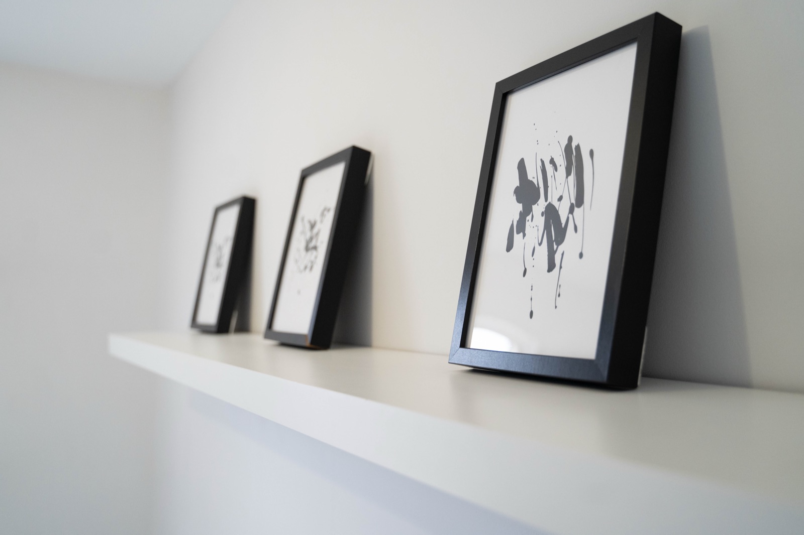 Detail at Cecil House — framed art on floating shelf