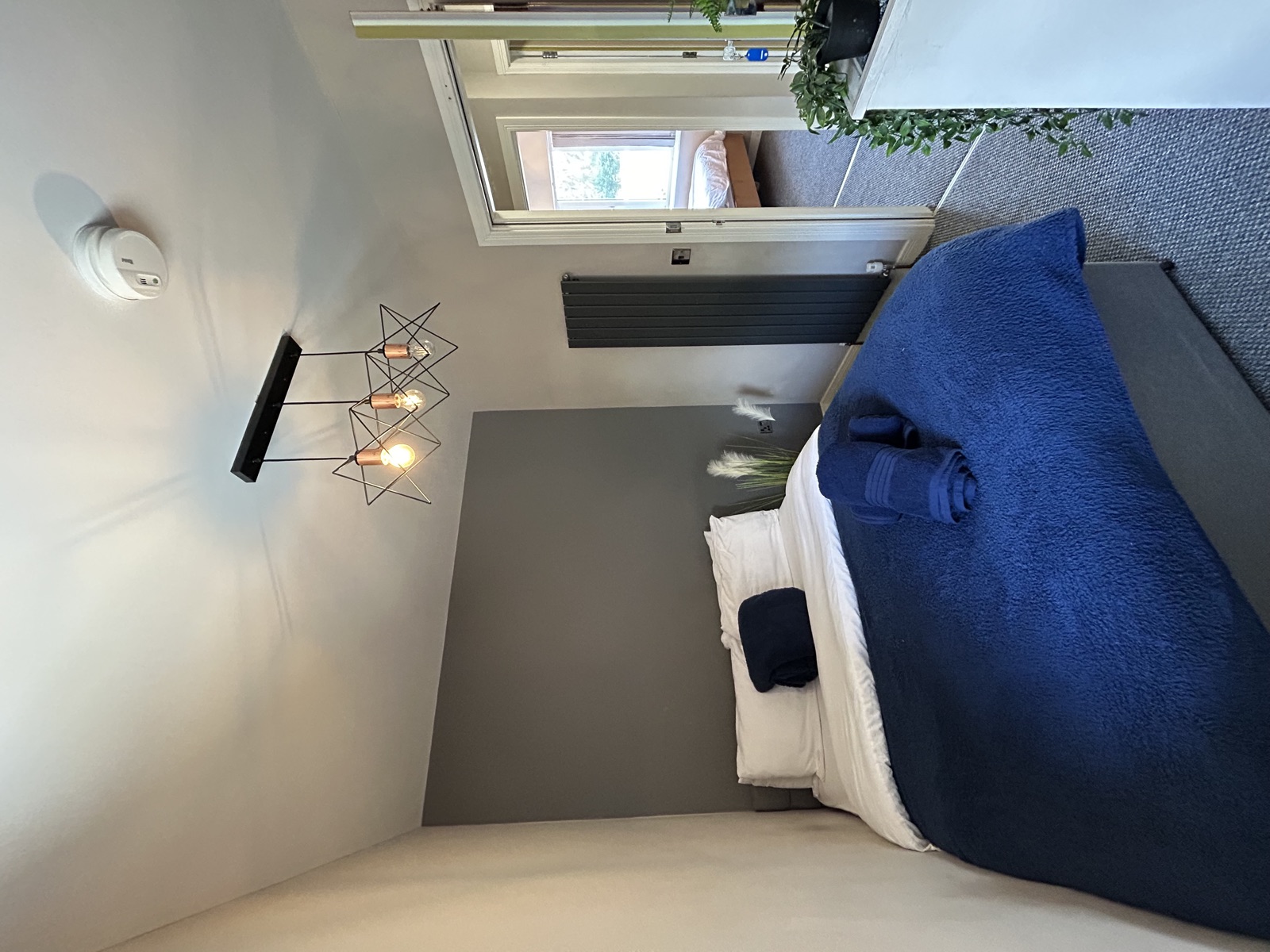 Bedroom at Cranbrook House — dark grey accent wall
