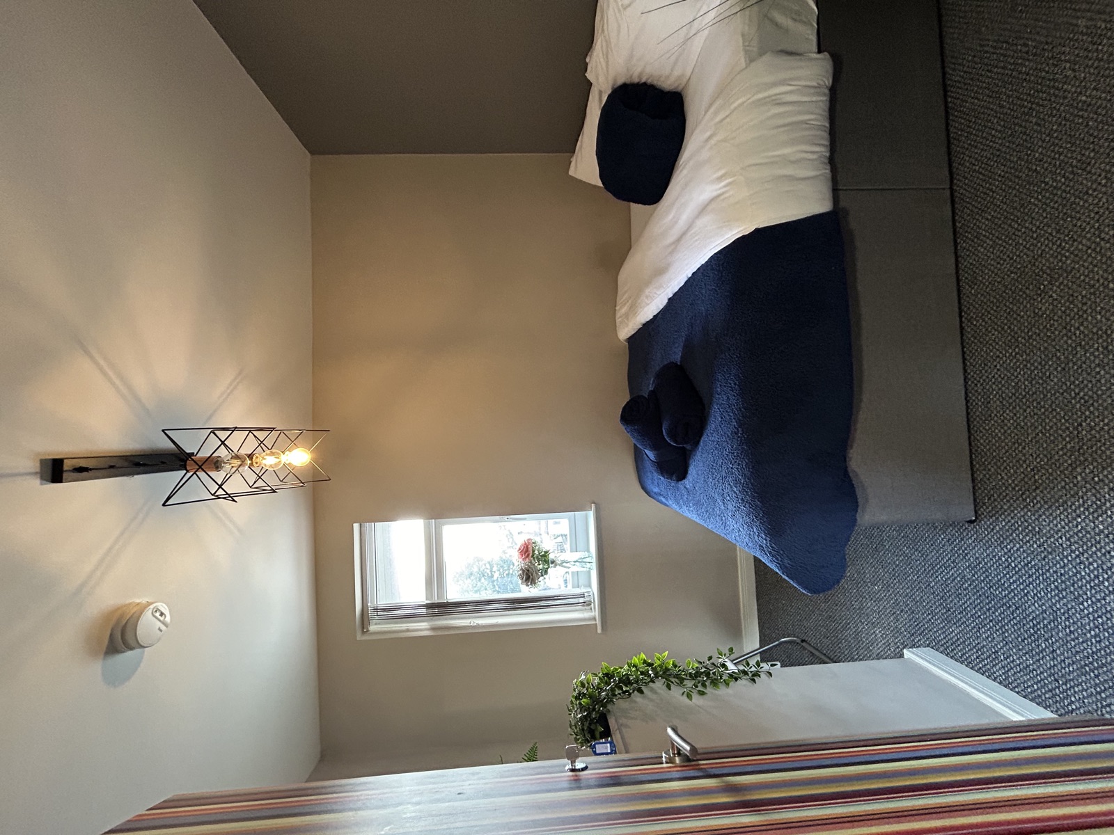 Bedroom at Cranbrook House — striped wallpaper accent