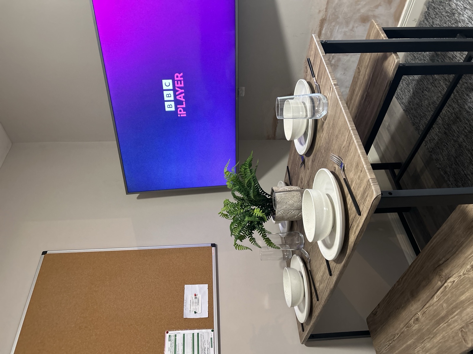 Dining area at Cranbrook House — table for four with mounted TV