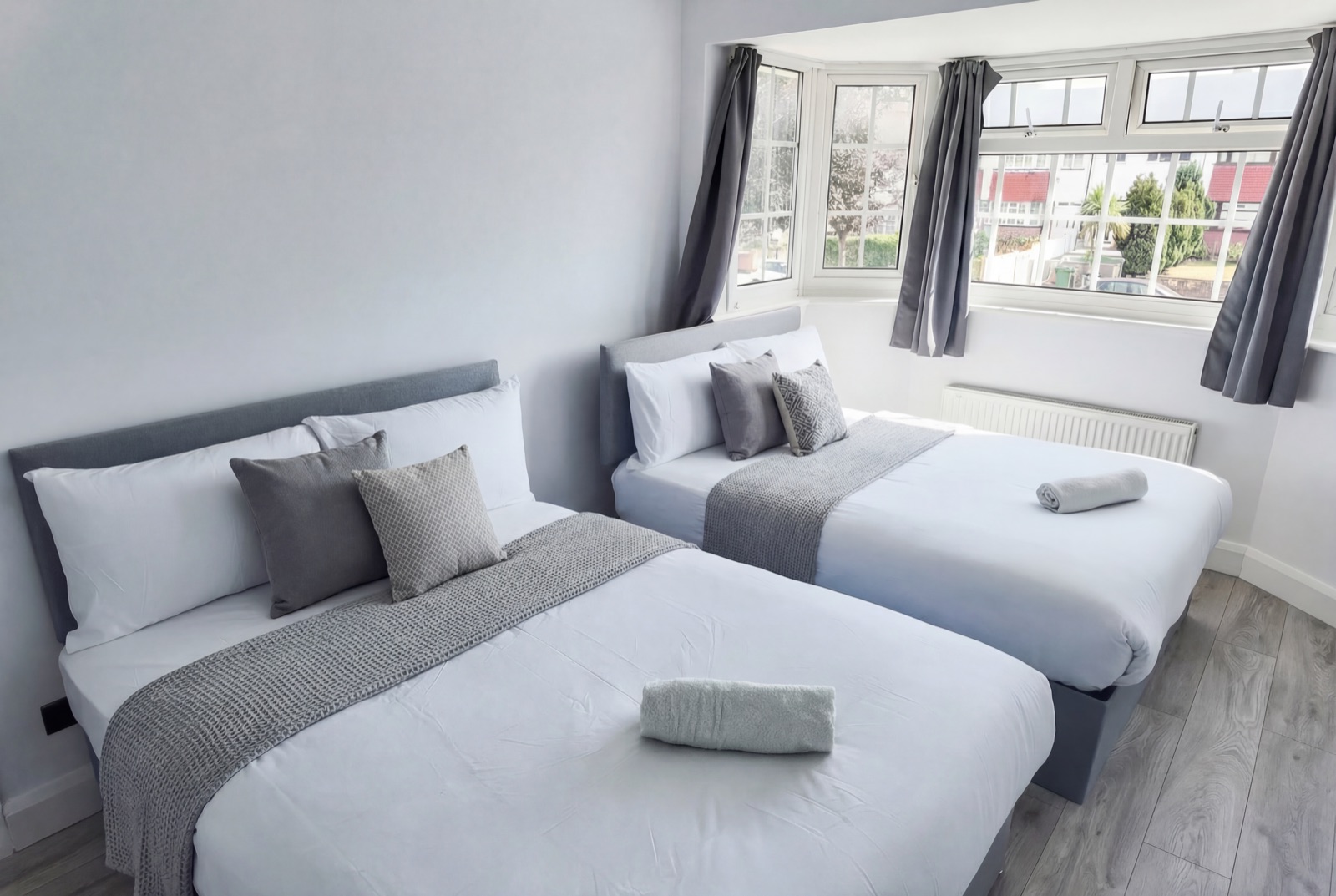 Master bedroom at Whitefoot House — grey velvet headboard